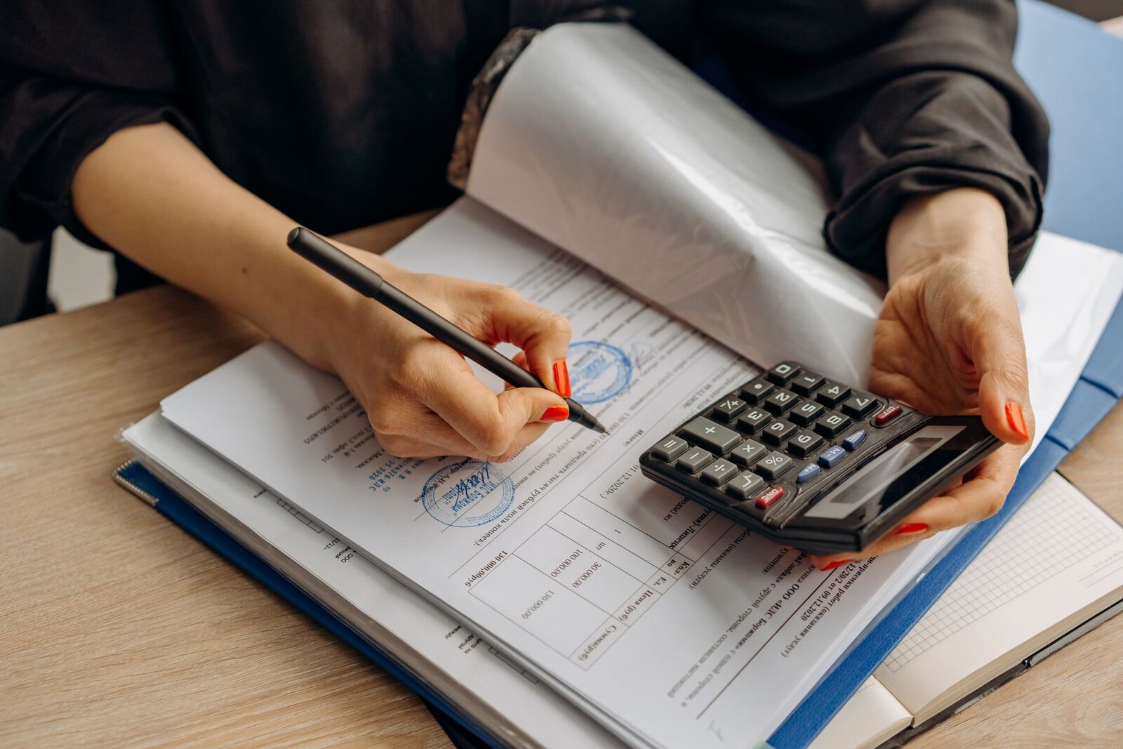 A calculator resting on financial documents on a desk